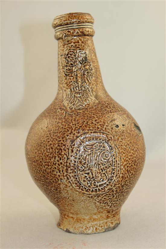 A German stoneware bellarmine jug, 16th / 17th century, 22cm.